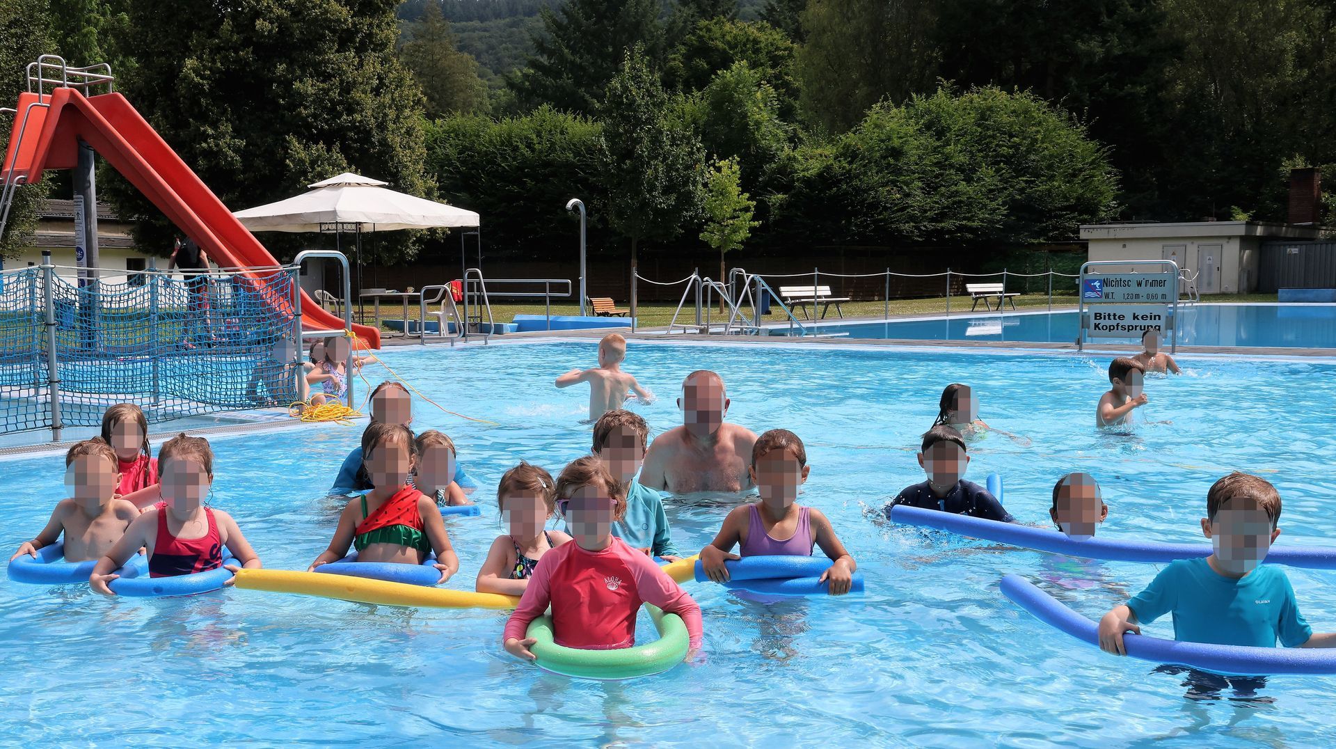 Das Ende einer Wasserrutsche mit einem großen Wasserplatscher einer Person.