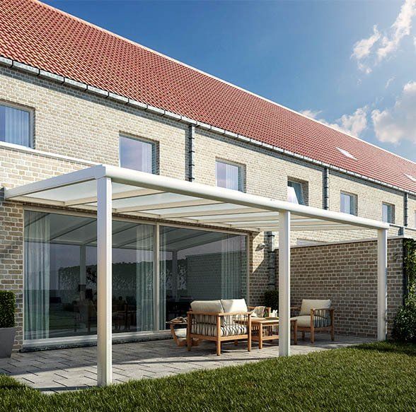 Pergola blanche avec panneaux latéraux en verre accolée à une maison en pierre