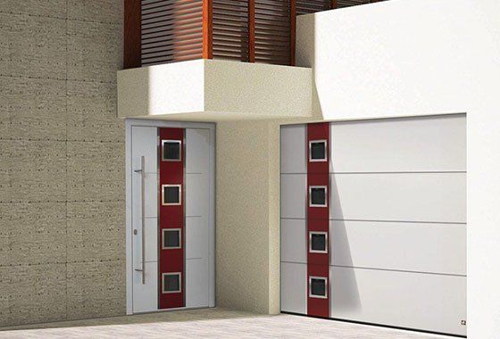 Porte de garage sectionnelle verticale à droite blanche et rouge et porte d'entrée accordée à gauche