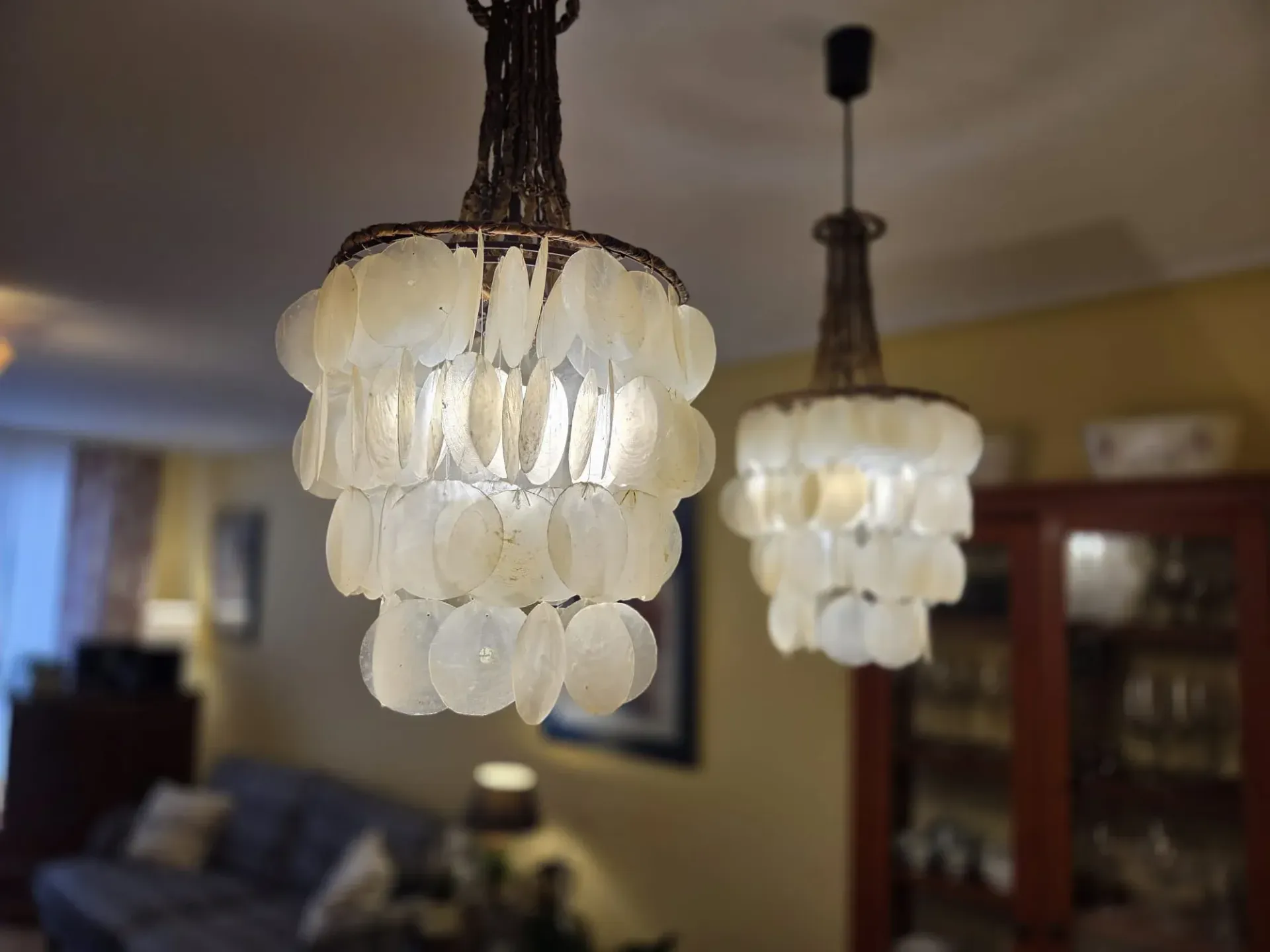 Dos lámparas colgantes de cristal esmerilado iluminan una acogedora sala de estar.
