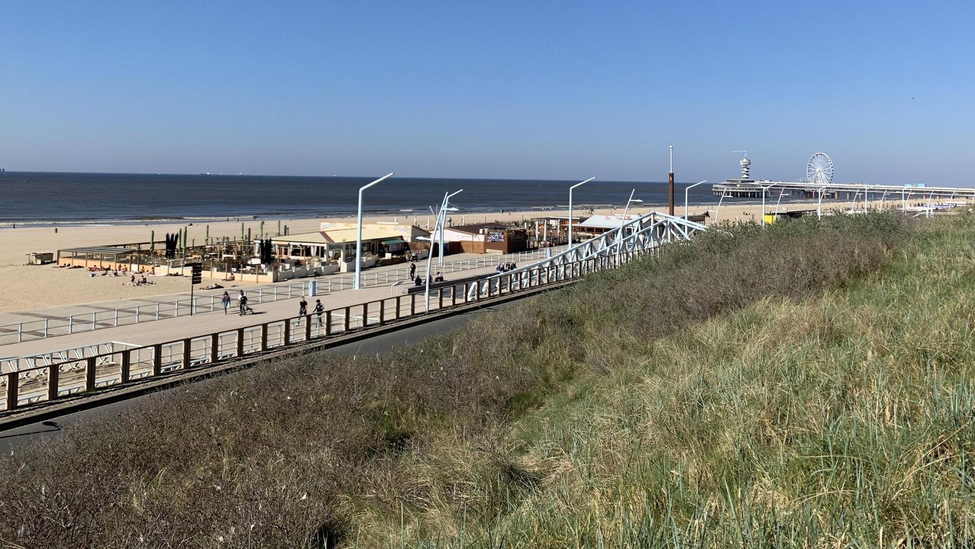 Een hek omringt een strand met uitzicht op de oceaan.