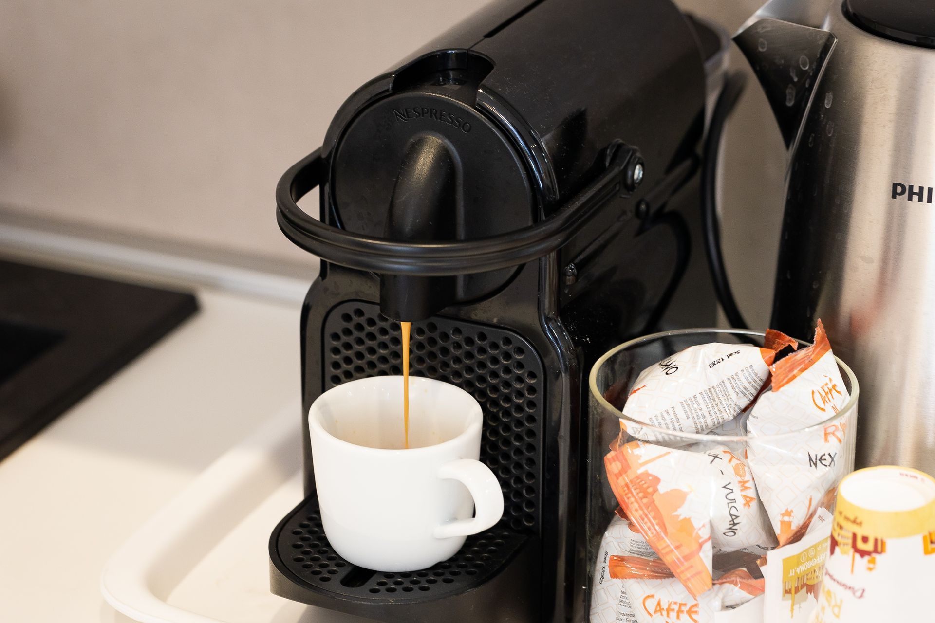 A coffee maker is making a cup of coffee.