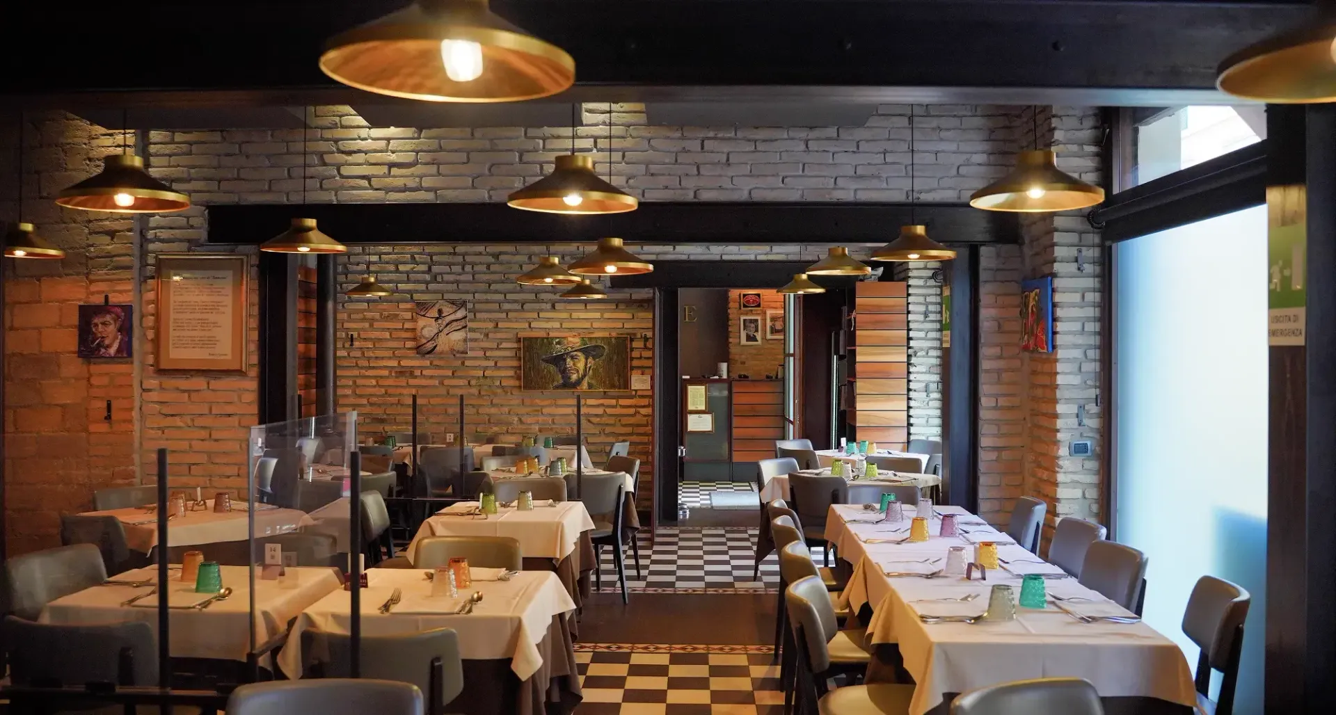 A restaurant with tables and chairs and a checkered floor.