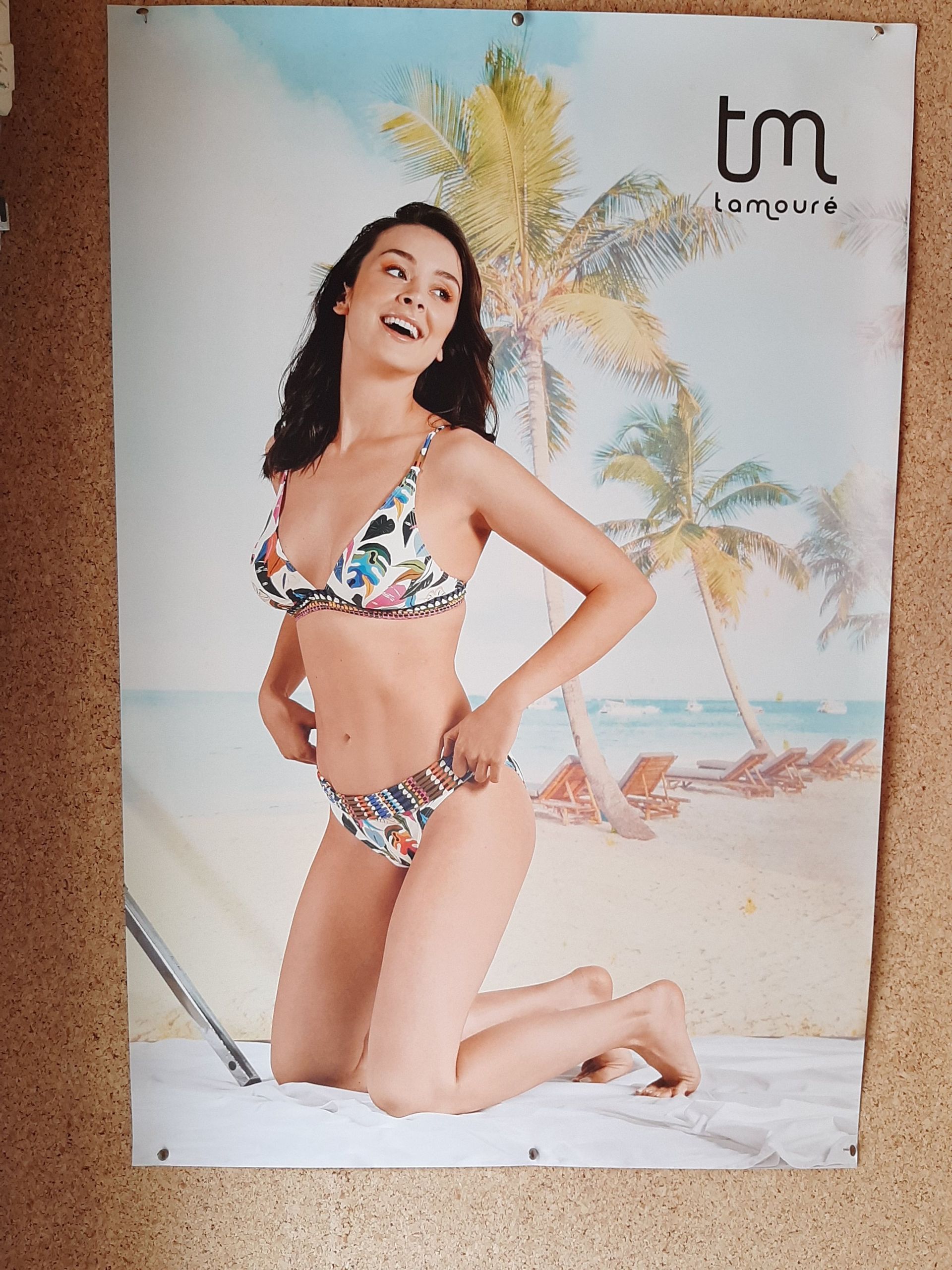 Un cartel de una mujer en bikini con la palabra tm en él.