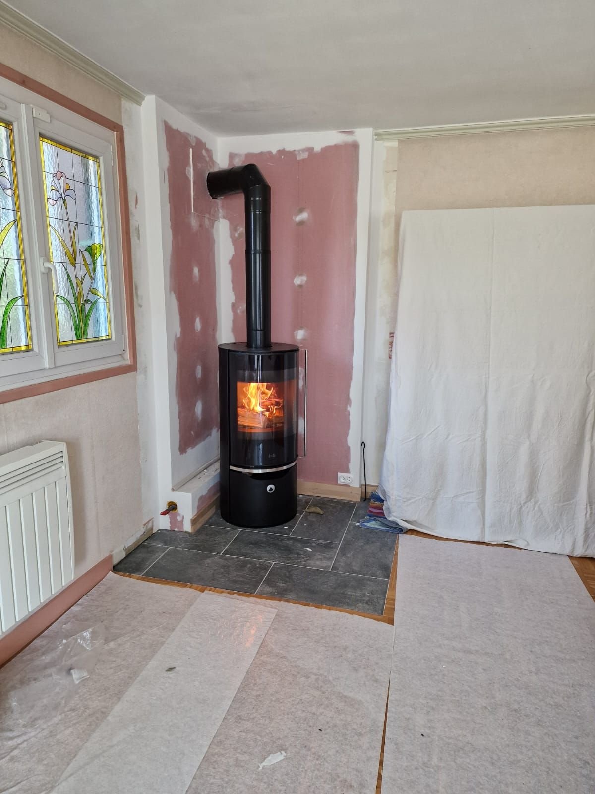 Poêle à bois en fonctionnement dans le coin d'une pièce