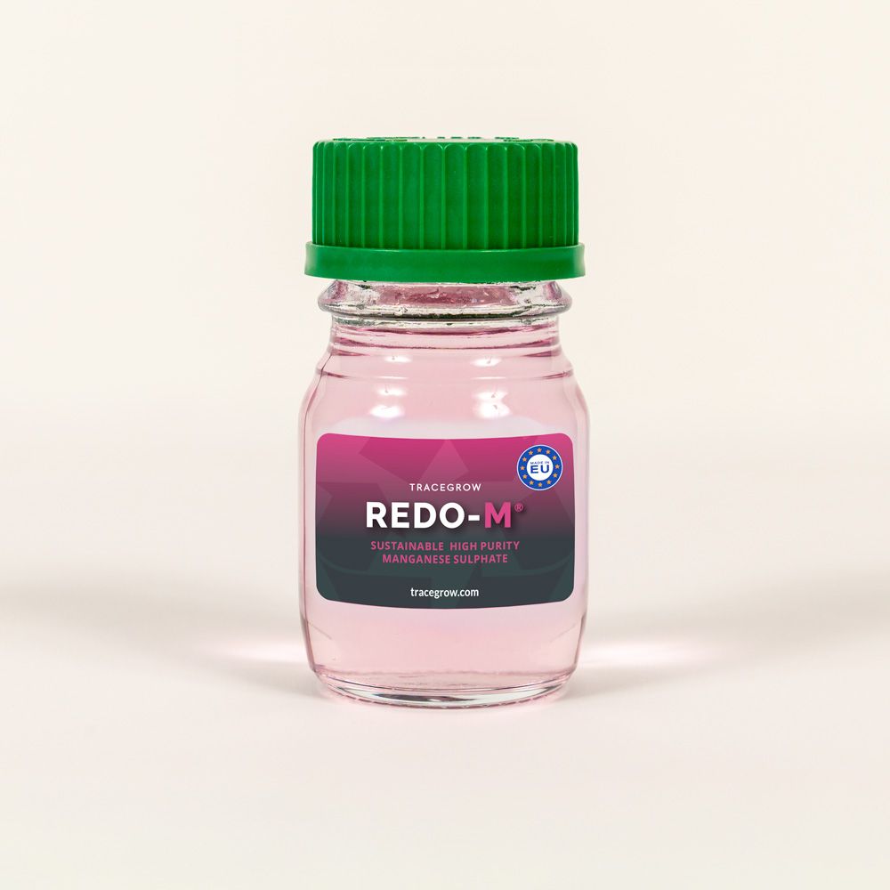 A small laboratory sample bottle labelled REDO-M® containing purified manganese solution developed b