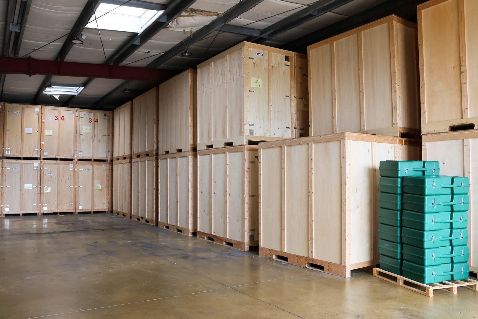 Deux vélos à côté d'un grand carton à l'intérieur d'un conteneur de rangement en bois
