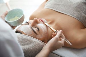 Eine Frau bekommt in einem Spa eine Gesichtsbehandlung.