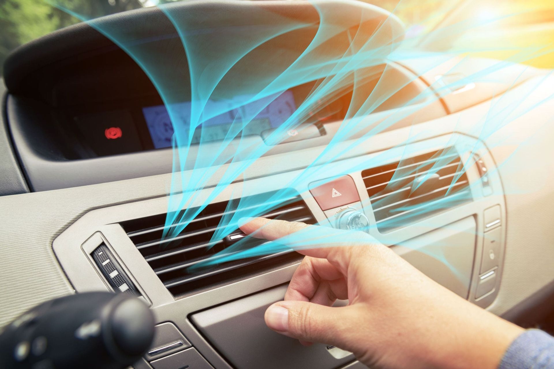 Una persona está ajustando el aire acondicionado de un automóvil.