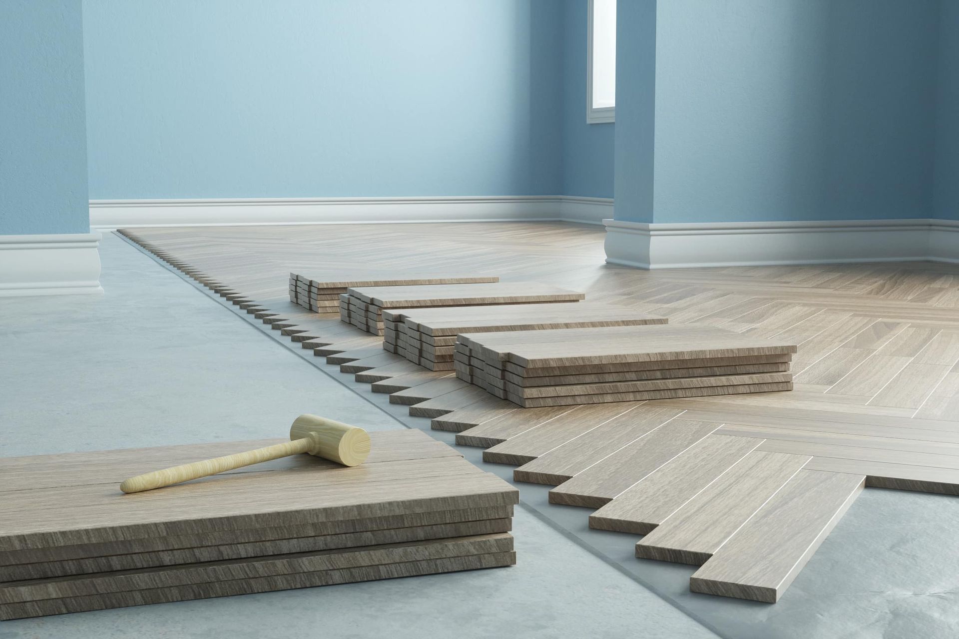 Se está instalando un piso de madera en una habitación con un martillo.
