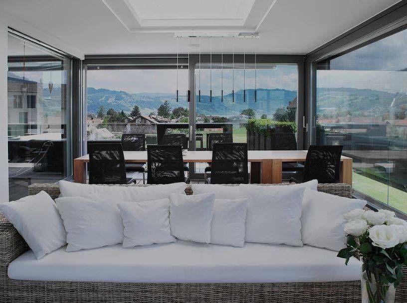 Ein Balkon mit Glasschiebetüren und Blick auf ein Gewässer. Foto von der Adolf Nussbaumer Fensterbau AG