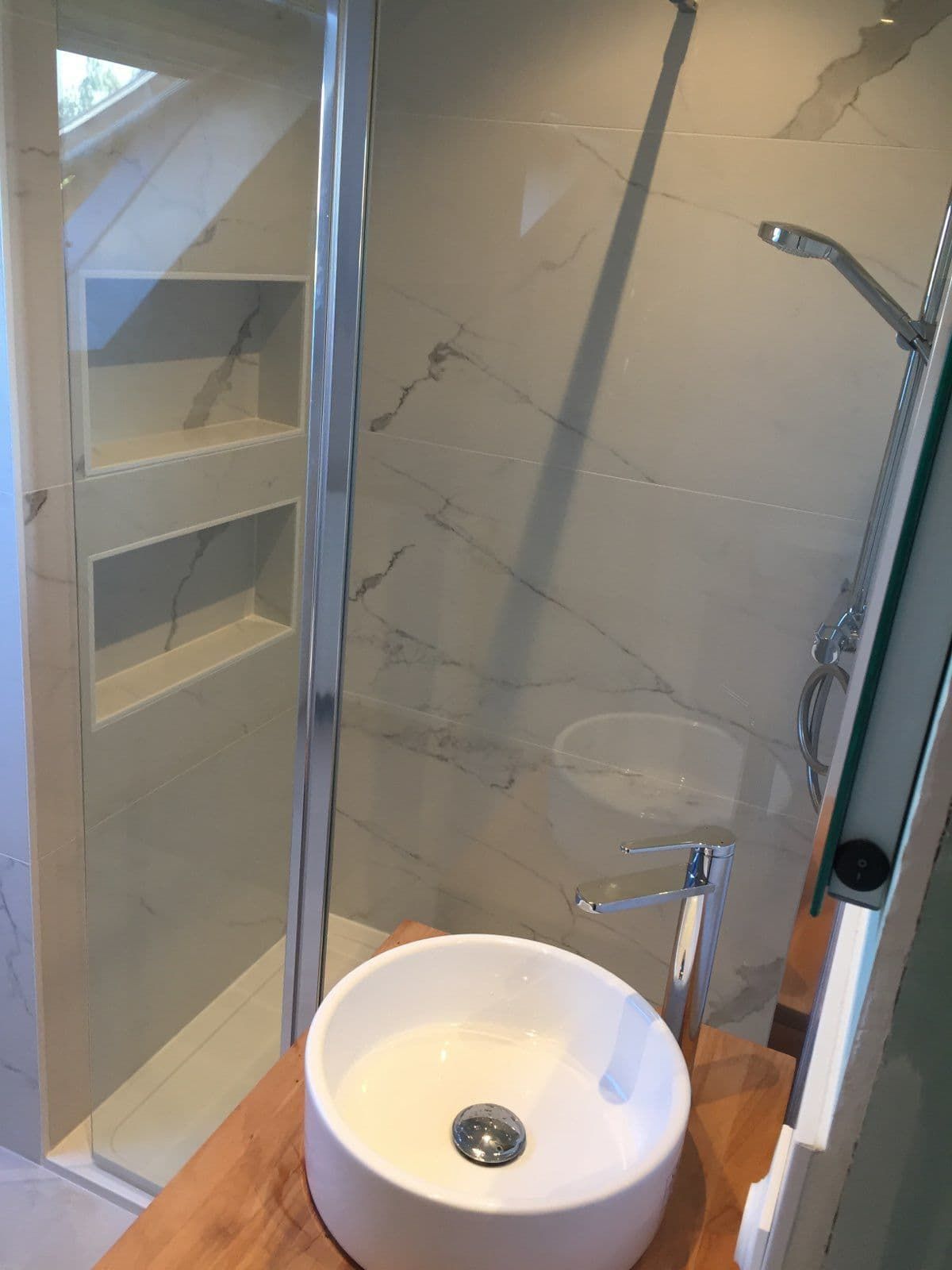 Un meuble vasque avec un lavabo circulaire et une douche