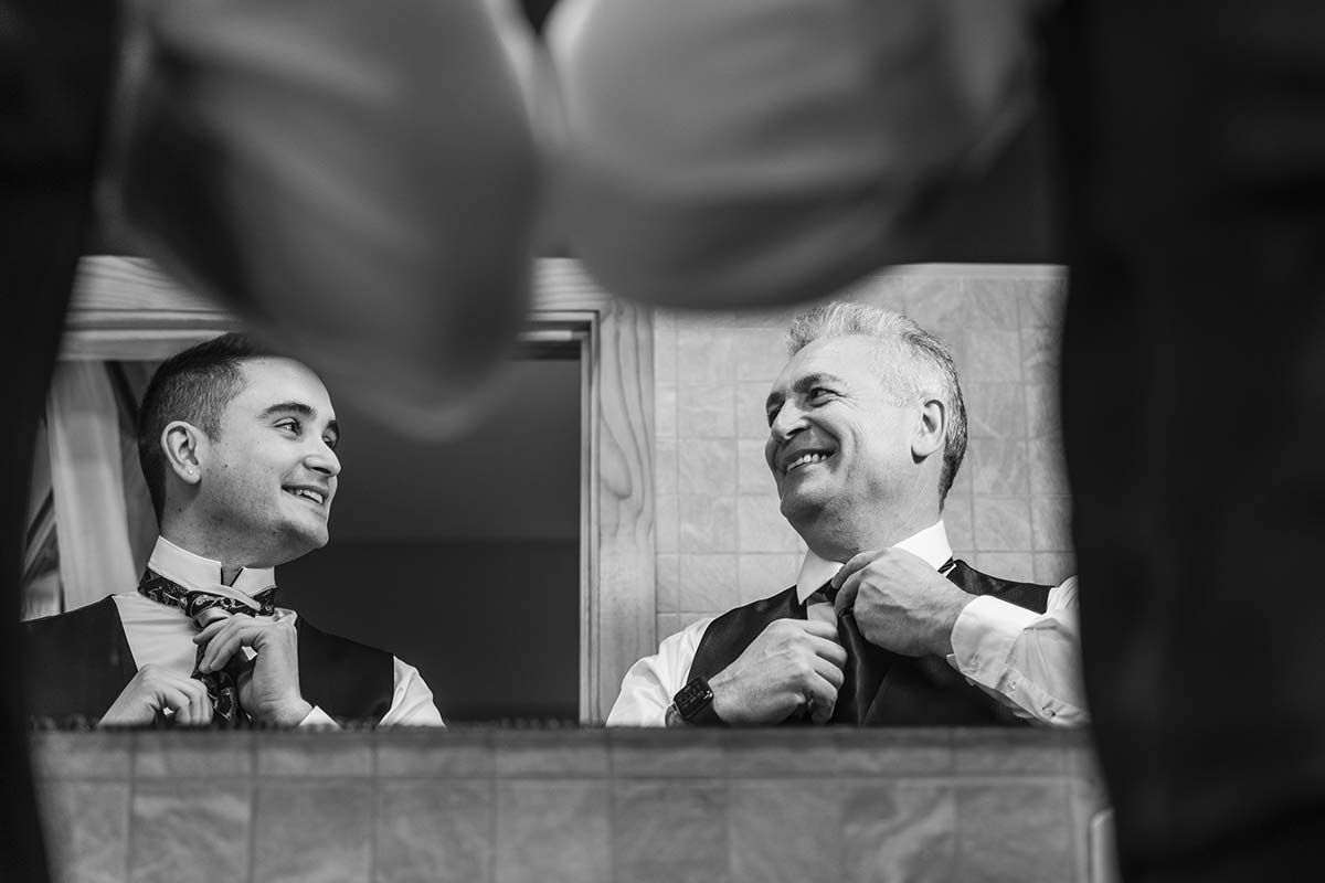 Una fotografía en blanco y negro de dos hombres preparándose para una boda.