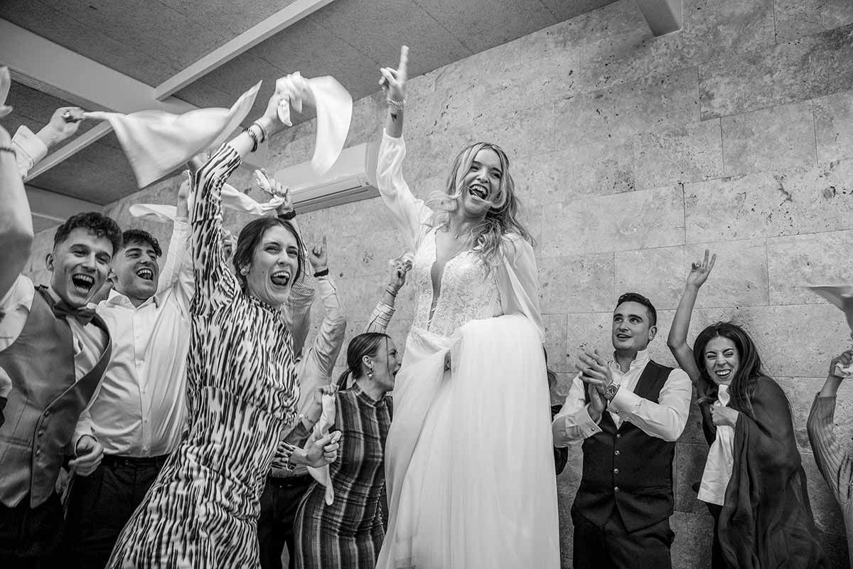 Una novia y un novio están bailando con sus invitados a la boda en la recepción.