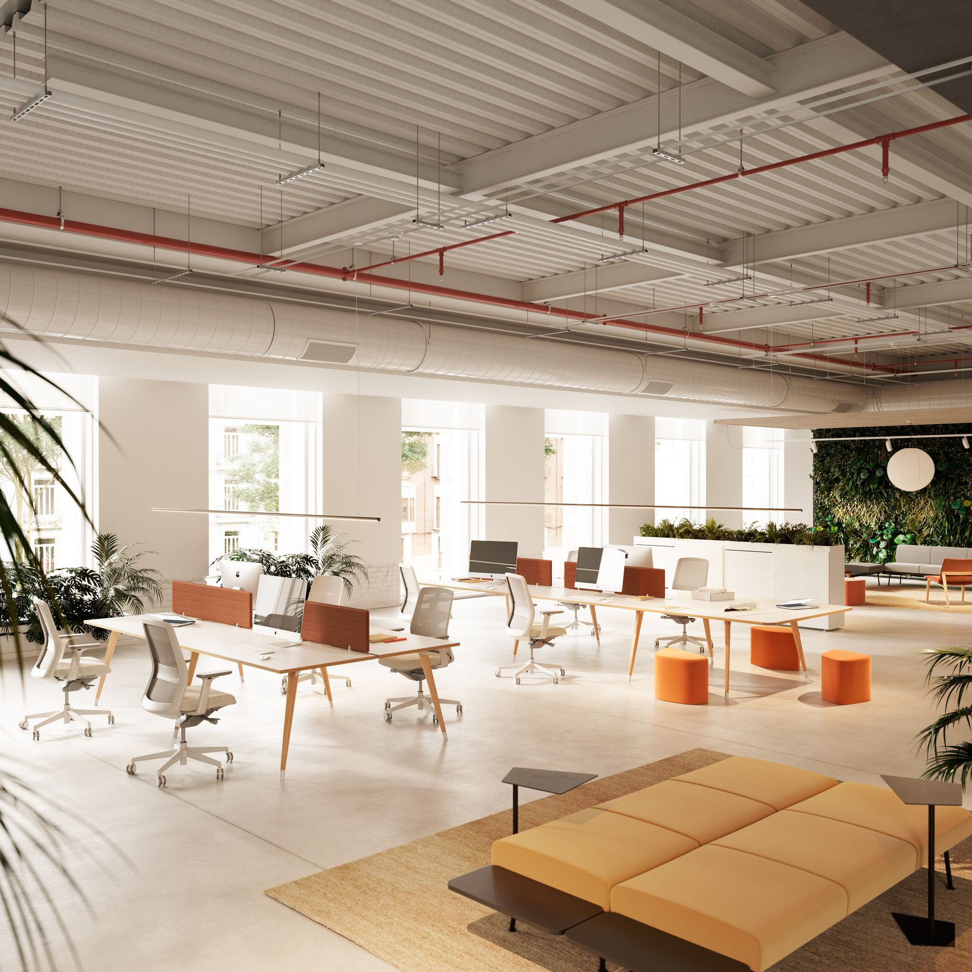 Open space avec plusieurs grands bureaux et espace detente