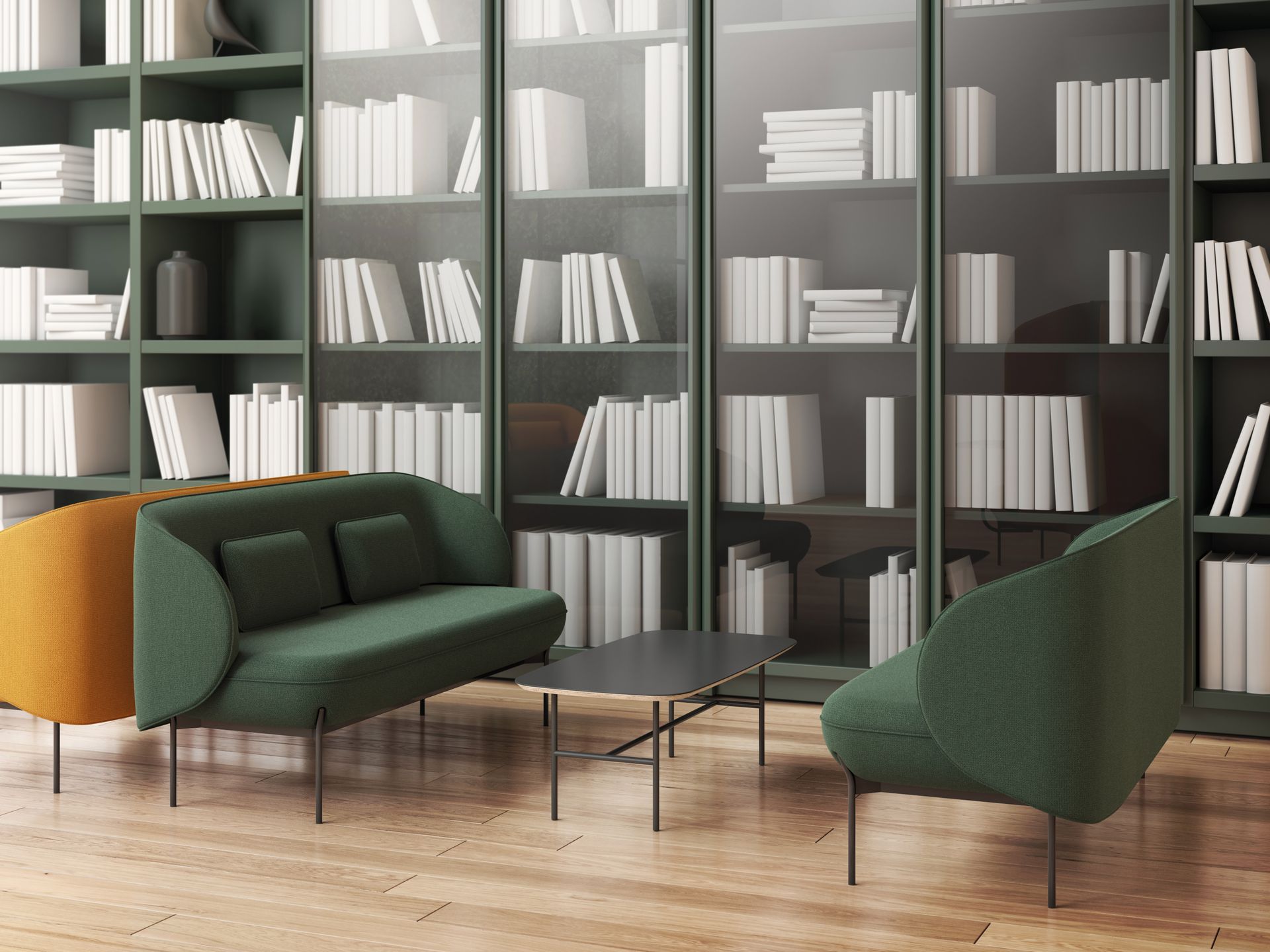 Petite table et banquettes vertes devant une bibliothèque