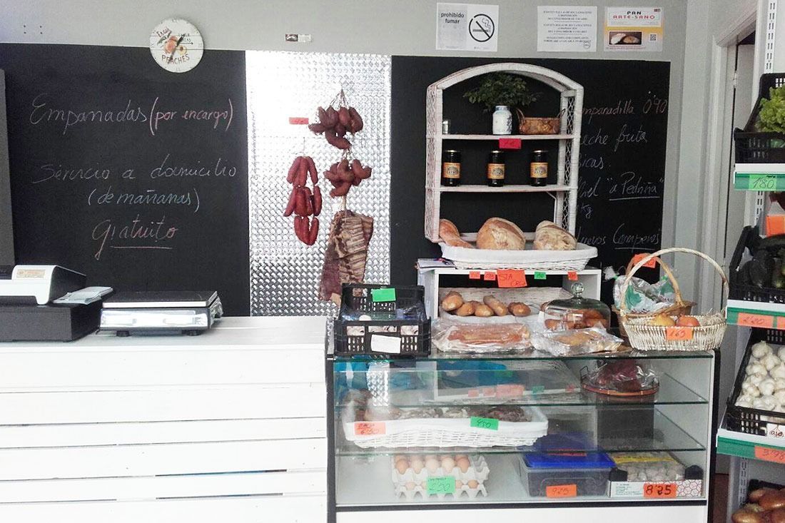 Una panadería con una vitrina de cristal y una pizarra en la pared.