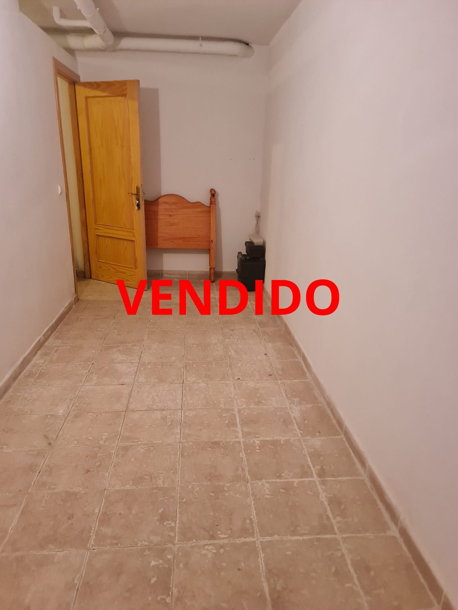 Una habitación con una cama y una puerta que dice vendido.