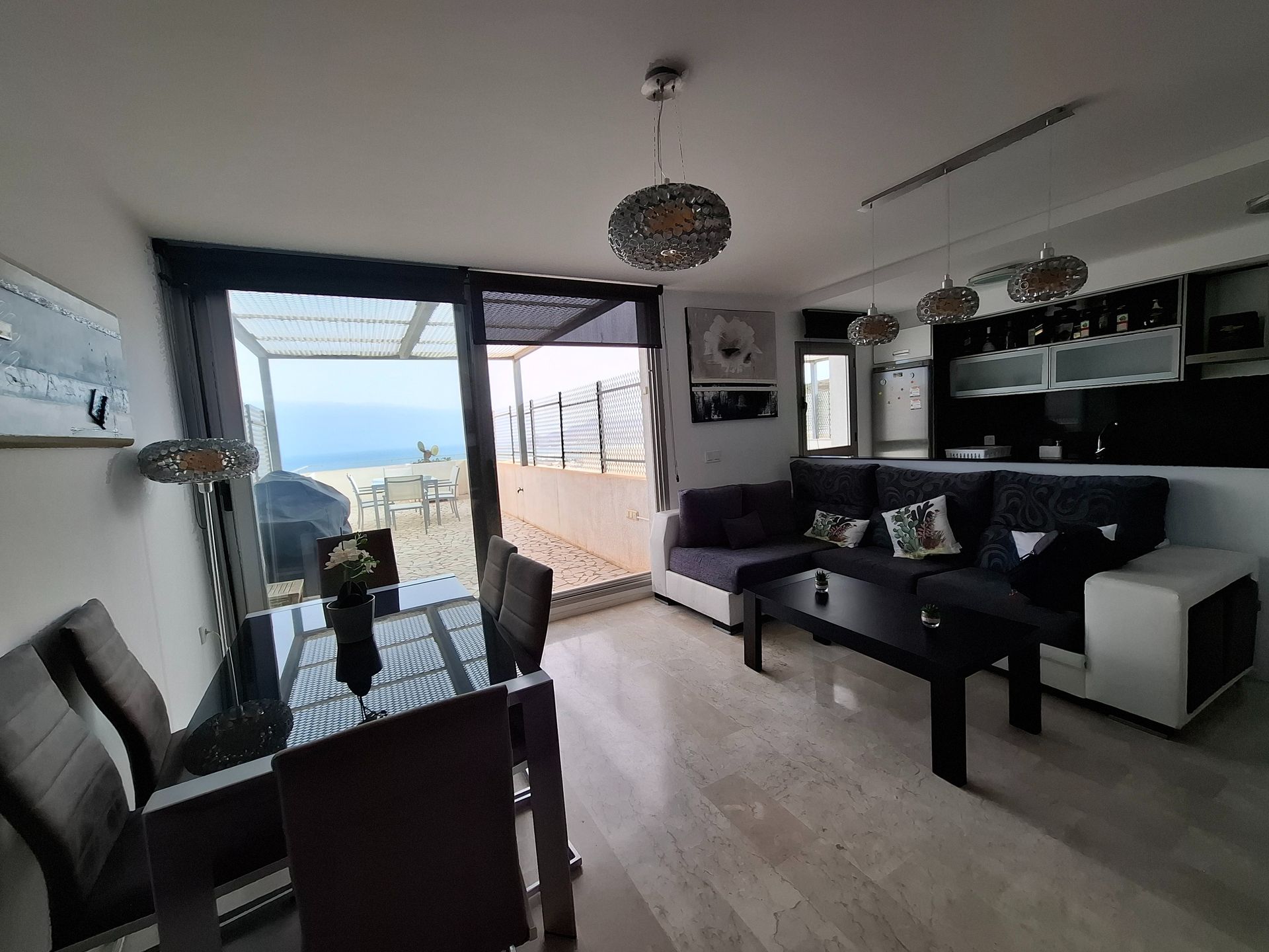 Una sala de estar con sofá, mesa y sillas.