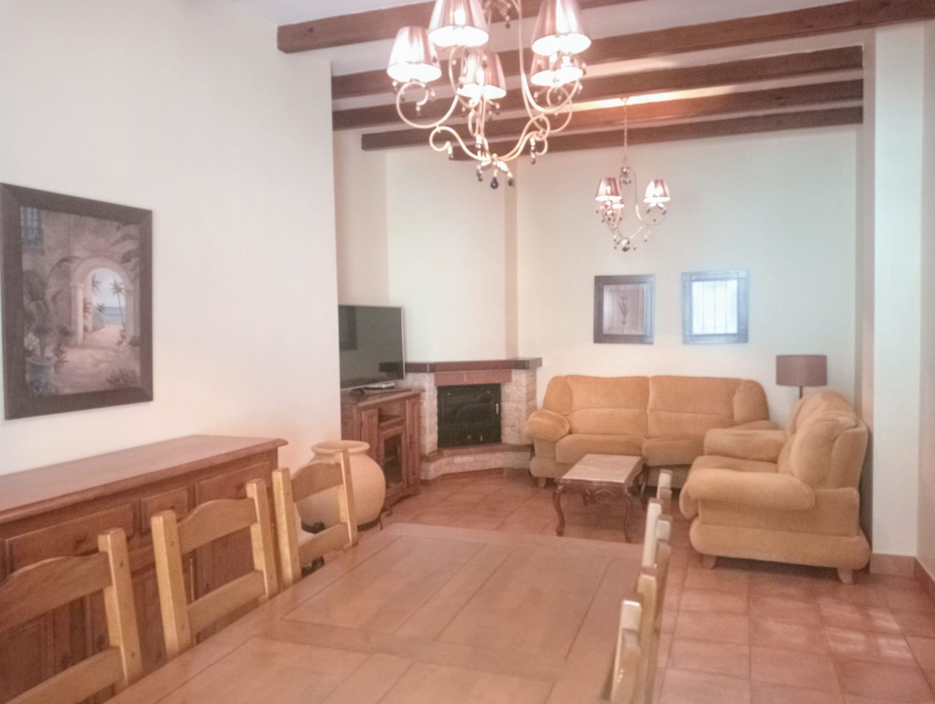 Una sala de estar con una mesa y sillas y un sofá.