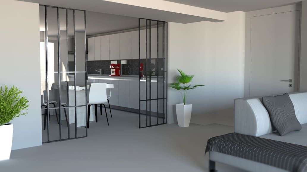 Puerta corrediza de cristal con rejilla negra, que separa una cocina moderna con isla y taburetes de otra estancia.