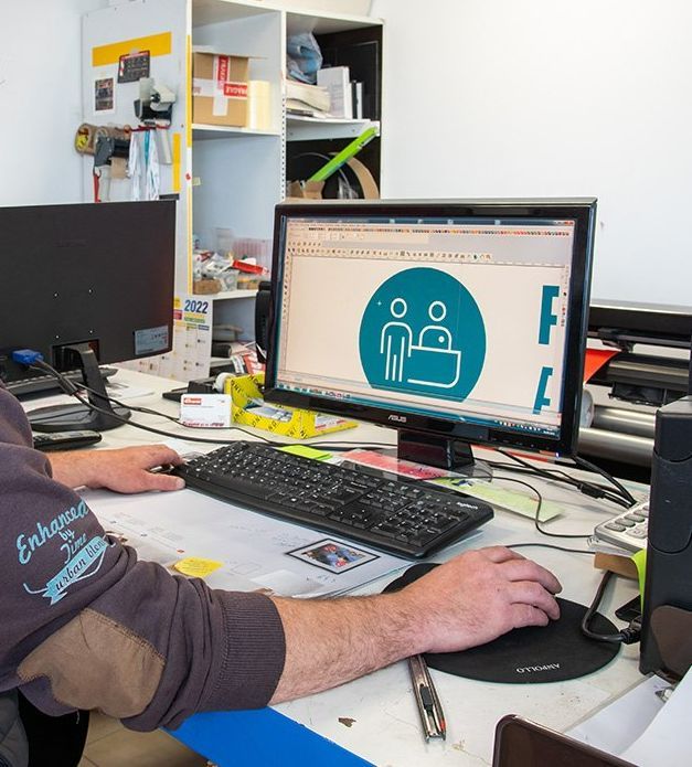 Graphiste suivant un brief et travaillant sur un ordinateur