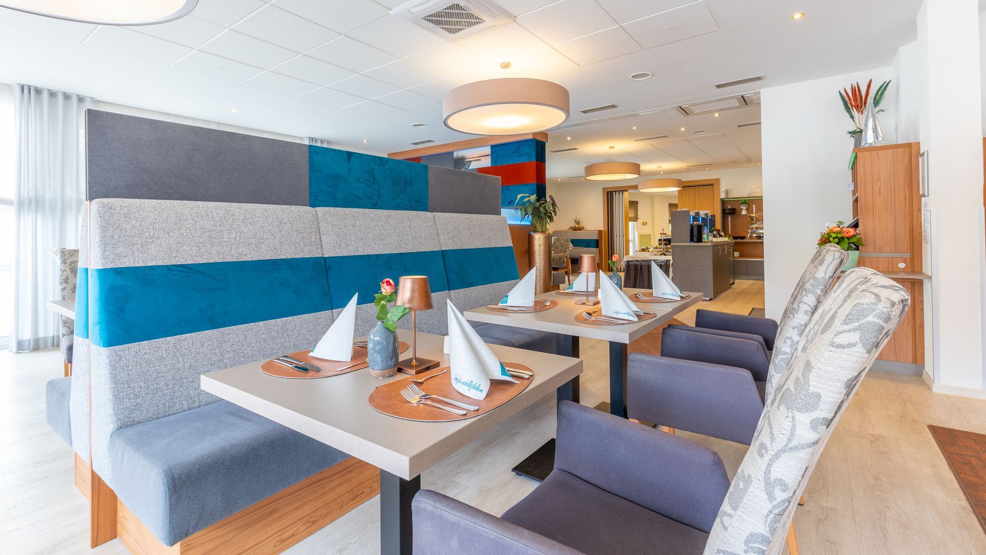 Ein Restaurant mit für eine Mahlzeit gedeckten Tischen und Stühlen.