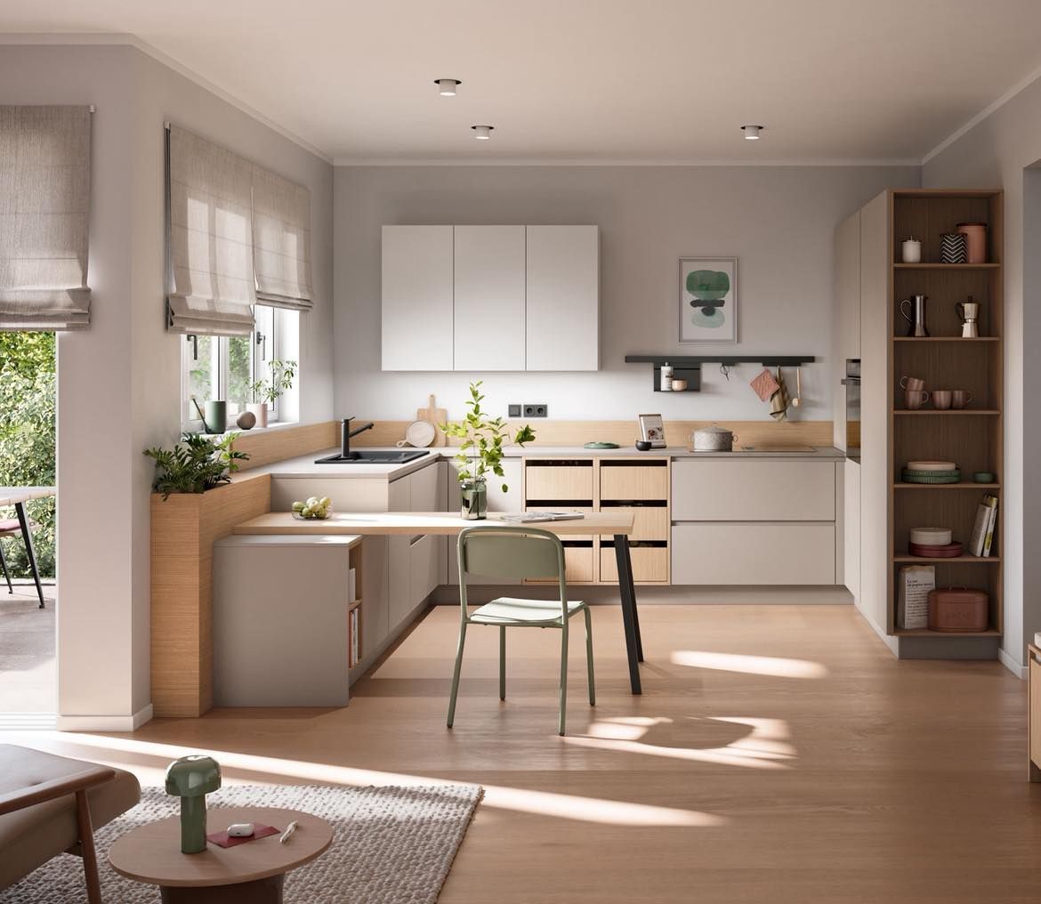 Cuisine moderne et lumineuse avec placards blancs, parquet, îlot central et lumière naturelle grâce à de grandes fenêtres