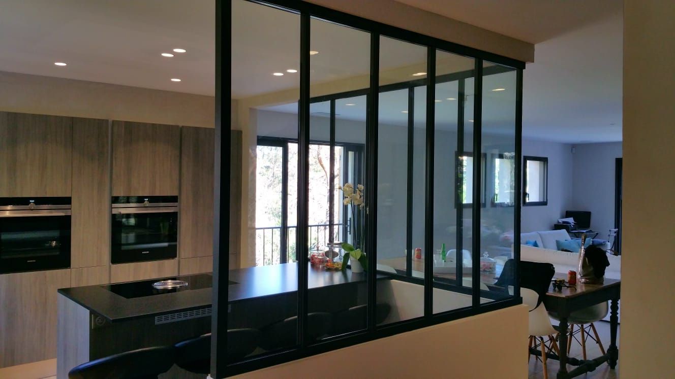 Cuisine avec cloison vitrée à cadre noir.