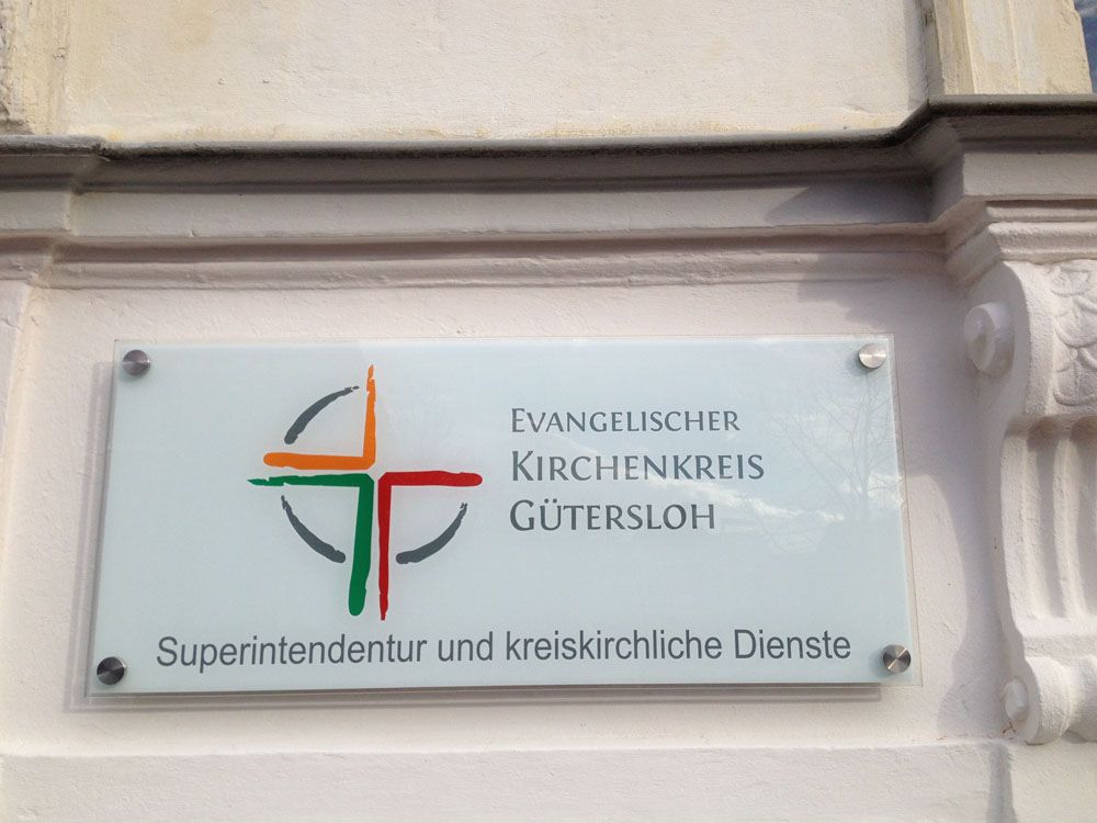 Ein Schild an der Seite eines Gebäudes mit der Aufschrift „Evangelischer Kirchenkreis Gutersloh“
