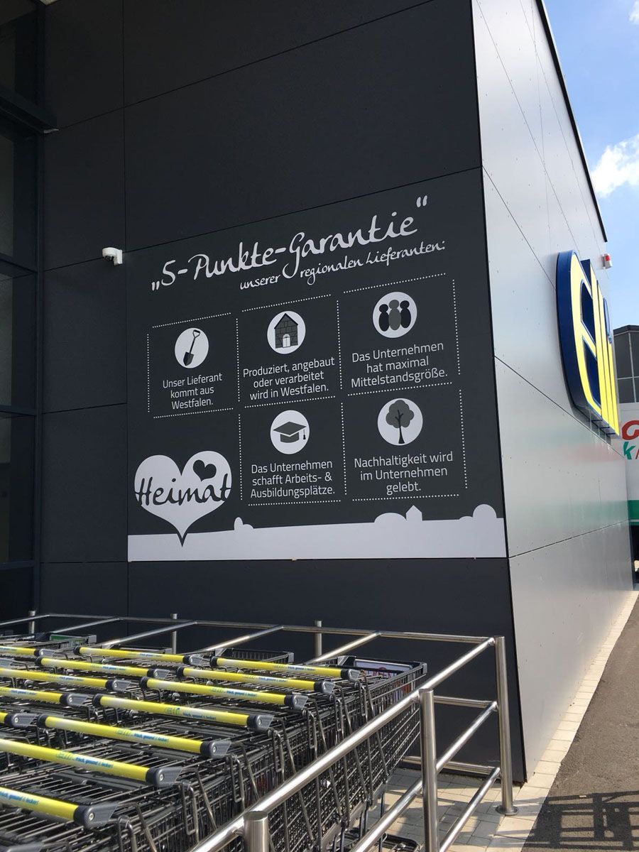 Eine Reihe von Einkaufswagen steht vor einem Geschäft