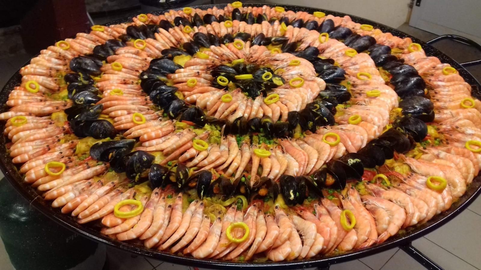 Plateau de paella parsemé de calamars.