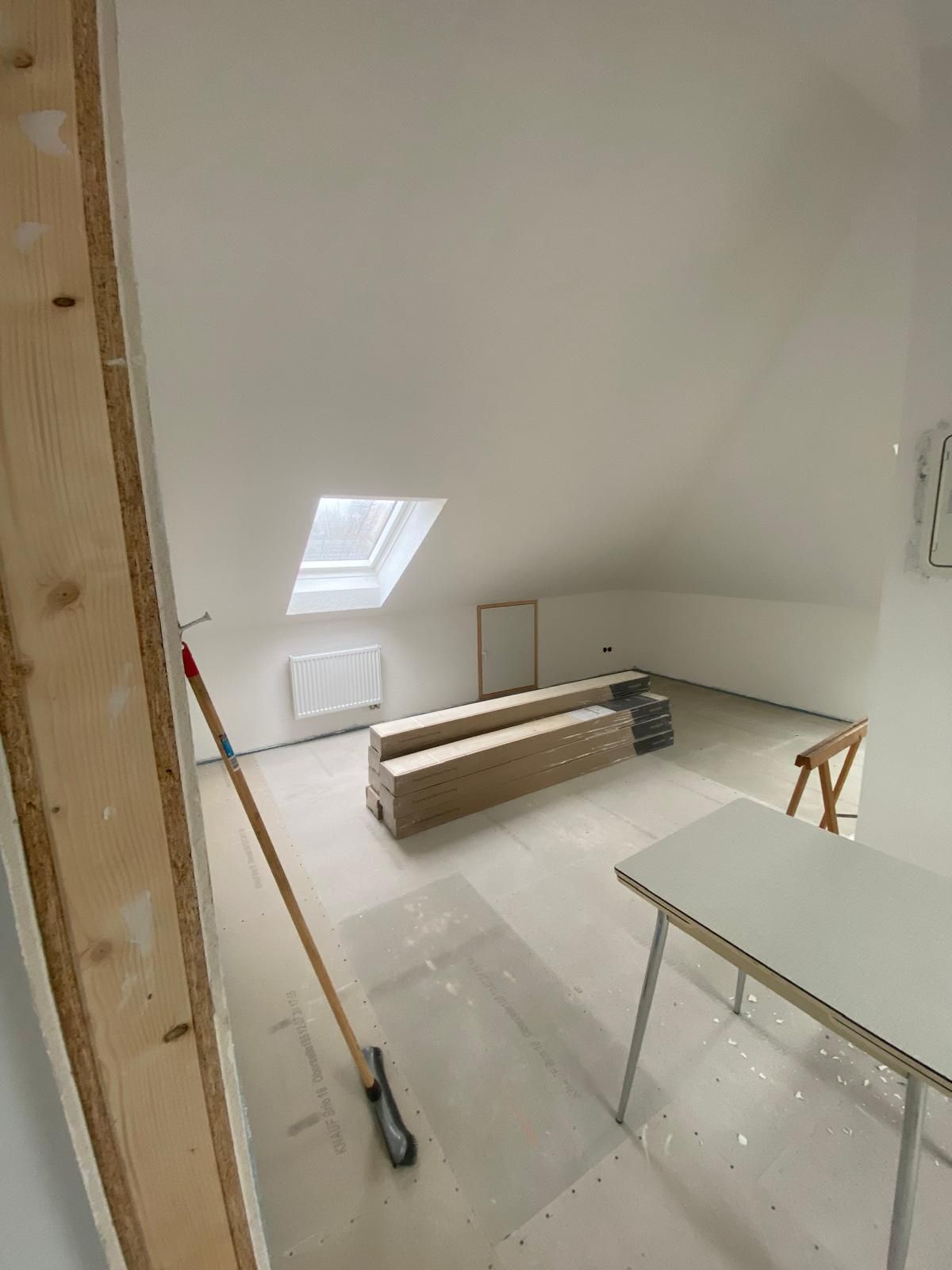 Ein Raum mit einem Tisch und einem Besen darin.