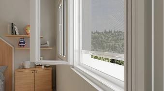 Une chambre avec une grande fenêtre et une armoire en bois.