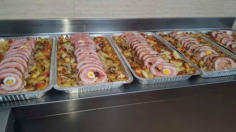 Un montón de bandejas de comida están colocadas encima de un mostrador.