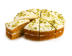 Tranches de gâteau aux carottes avec glaçage blanc et garniture de pistaches.