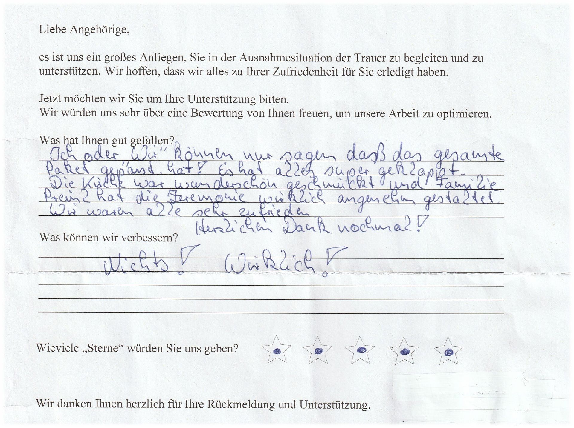 Handschriftliches Feedbackformular mit deutschem Text und Sternebewertungen.