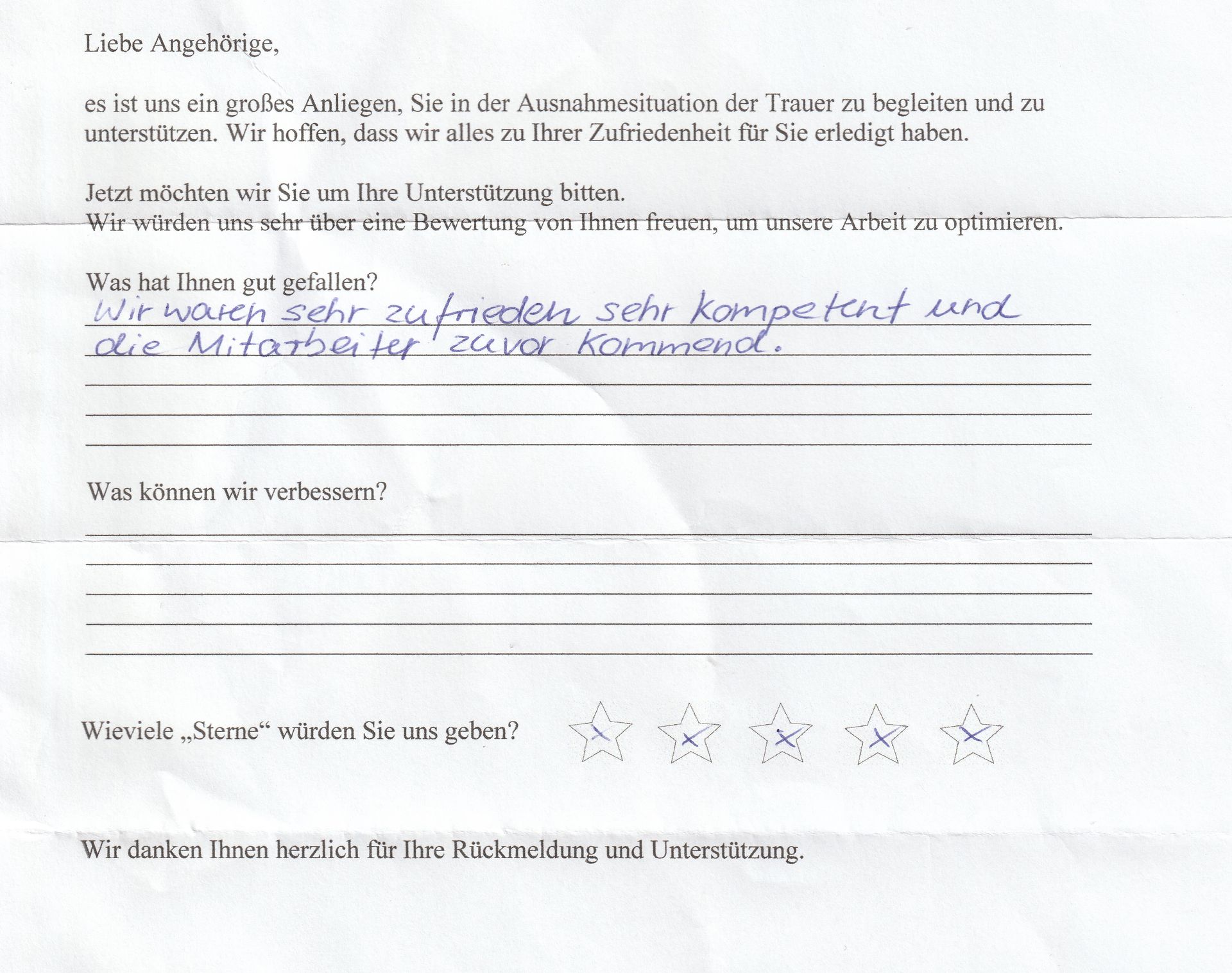 Handschriftliches Feedbackformular mit Text und Sternebewertung.