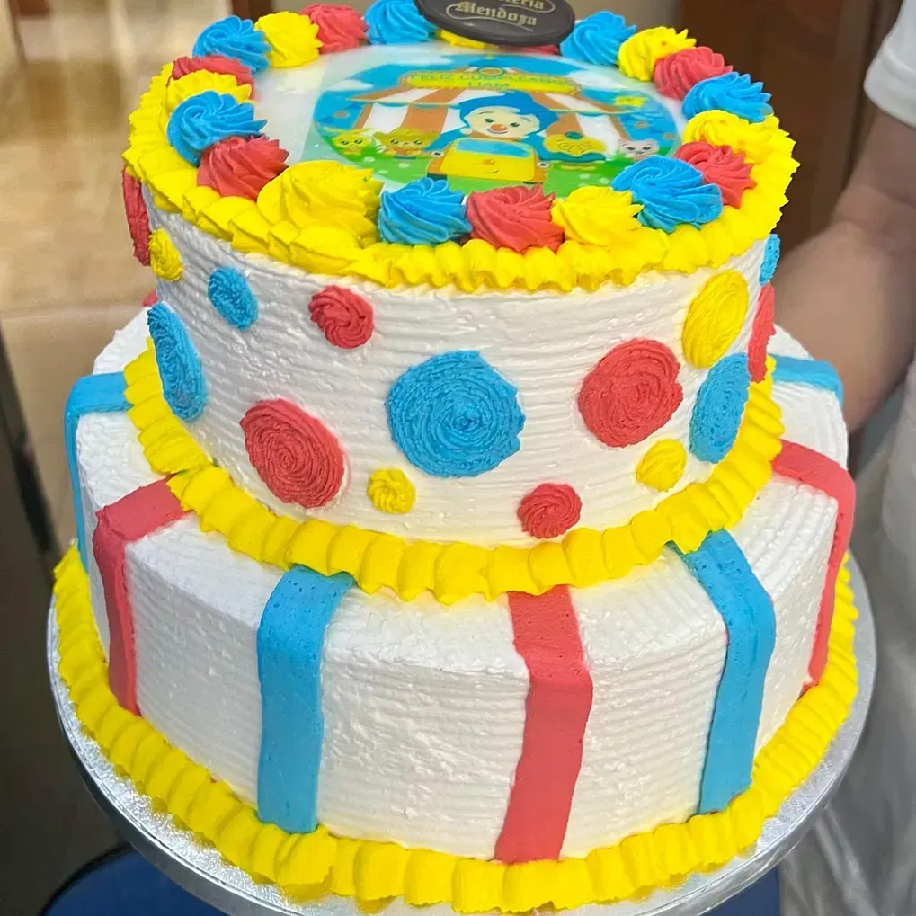 Una persona sostiene un pastel con la imagen de un mono.