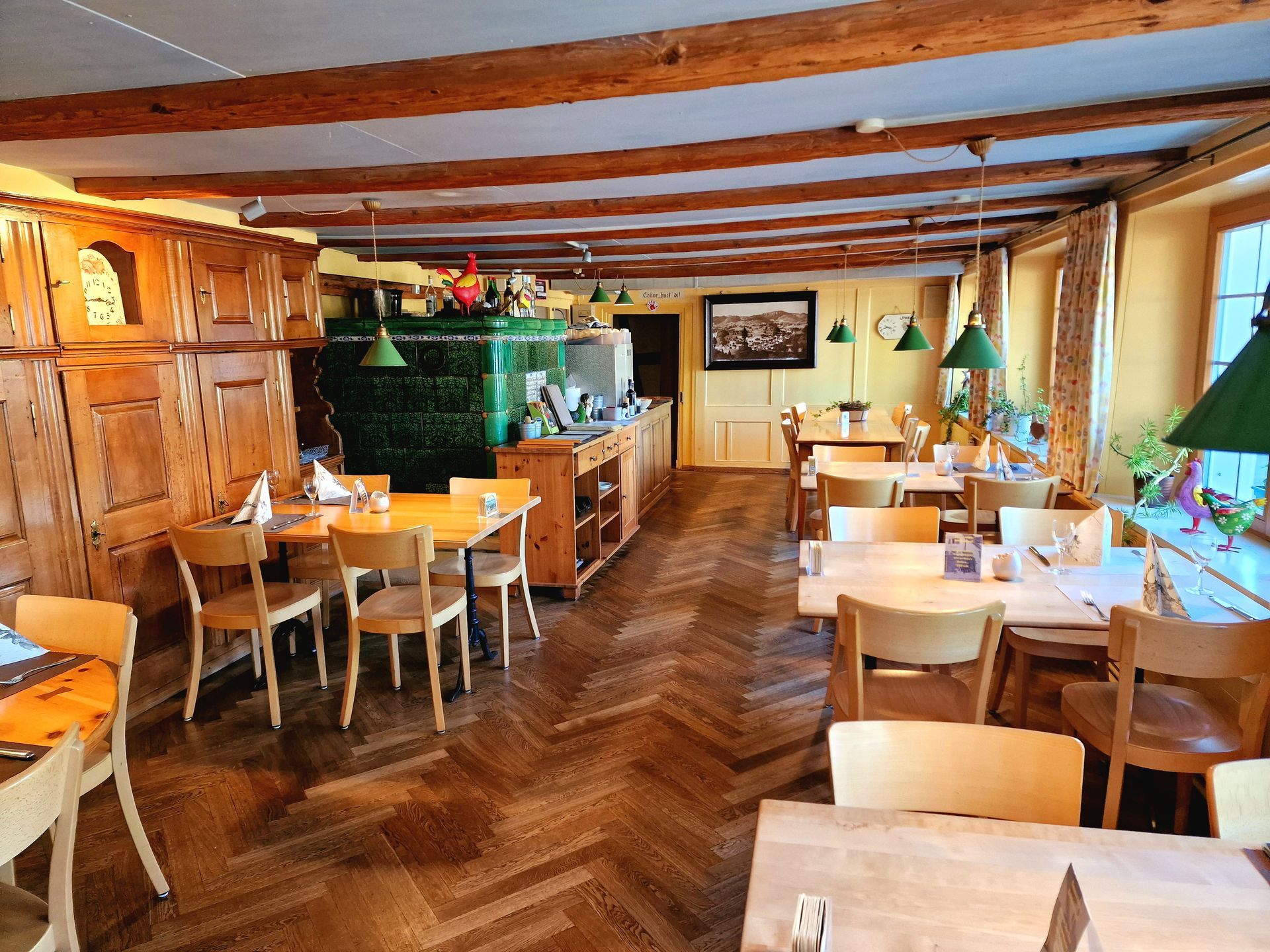 Esszimmer aus Holz mit gedecktem Tisch, Geweih an der Wand und einem Fenster.