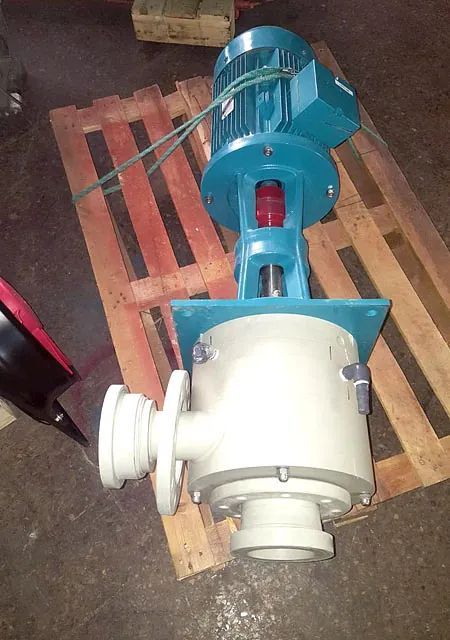 Una bomba azul y blanca está colocada sobre una paleta de madera.