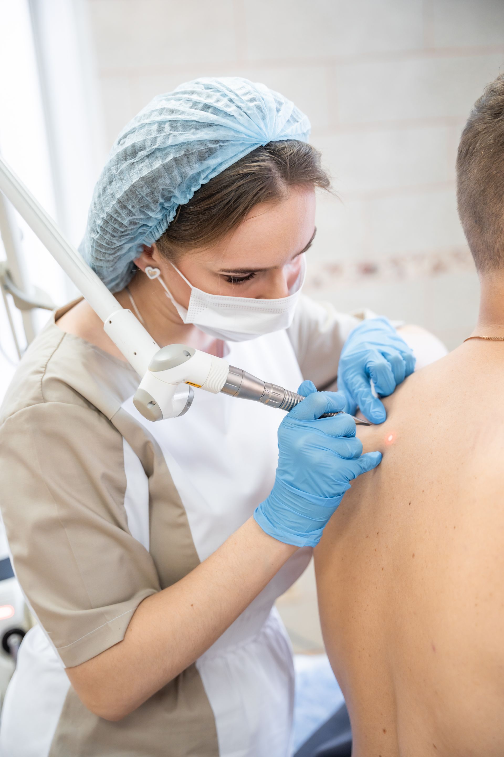 Dermatologista a aplicar tratamento no rosto de paciente