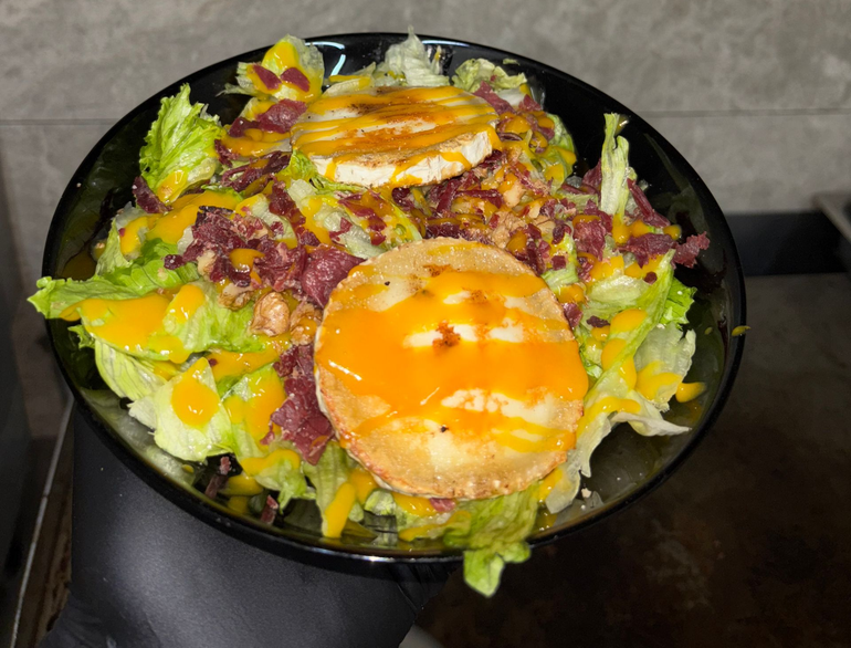 Un primer plano de un plato de comida con aguacate y semillas de sésamo.