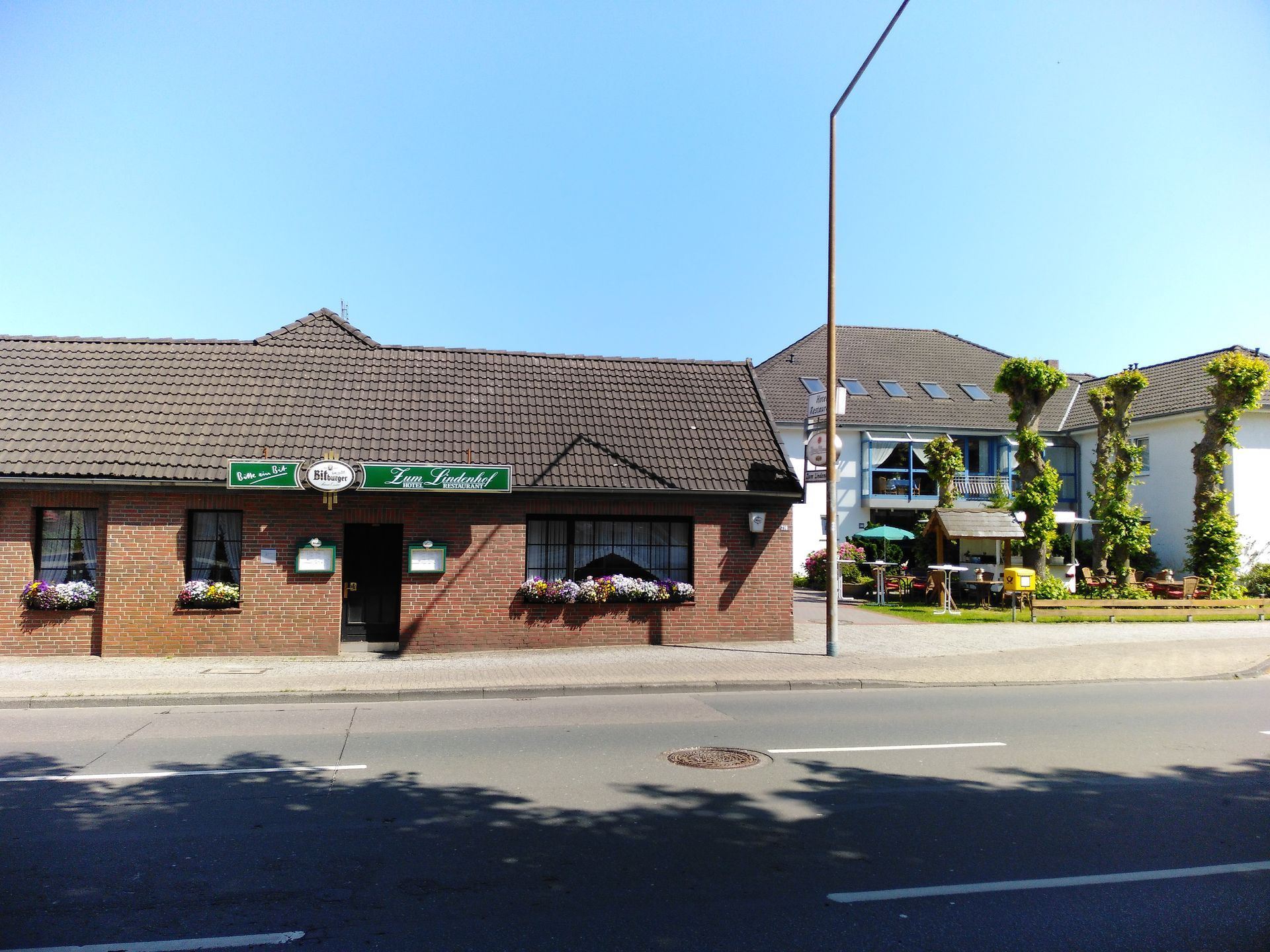 Ein Backsteingebäude mit einem grünen Schild mit der Aufschrift „Café“