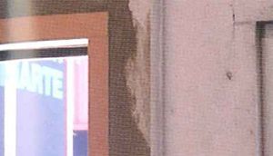 Un primer plano de una pared con un cuadro en ella.