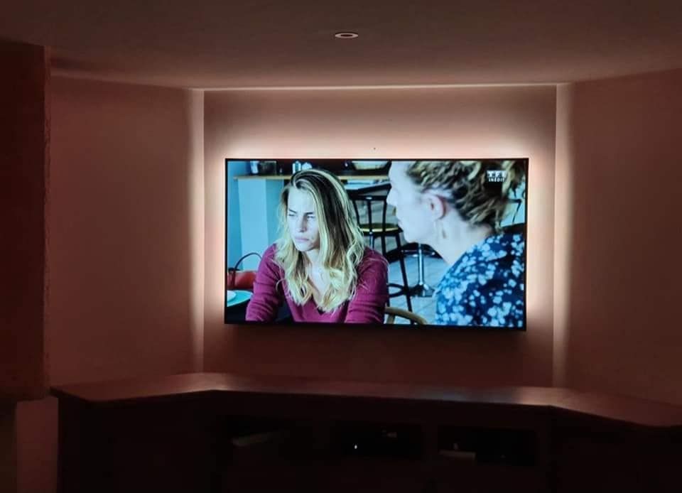Une télévision accroché dans le mur d'une chambre