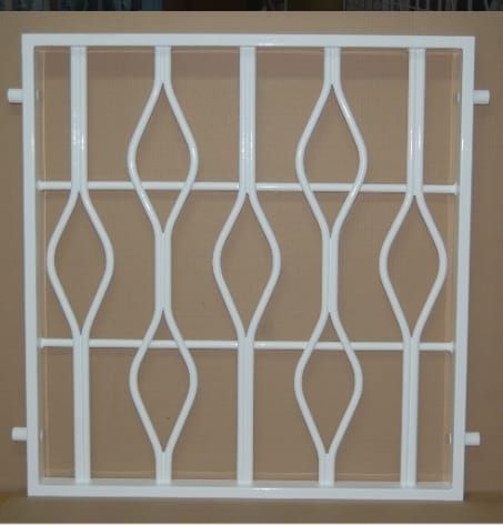 Una valla de hierro forjado blanca se encuentra sobre una superficie marrón.