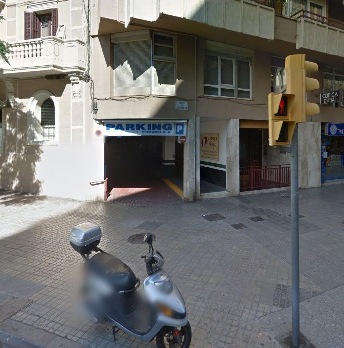 Un scooter está estacionado frente a un estacionamiento