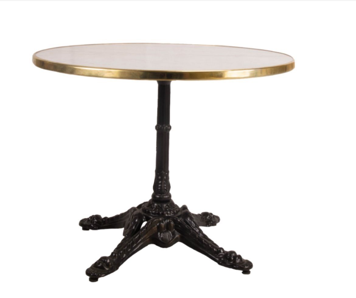 Una mesa redonda con base negra y tablero blanco.