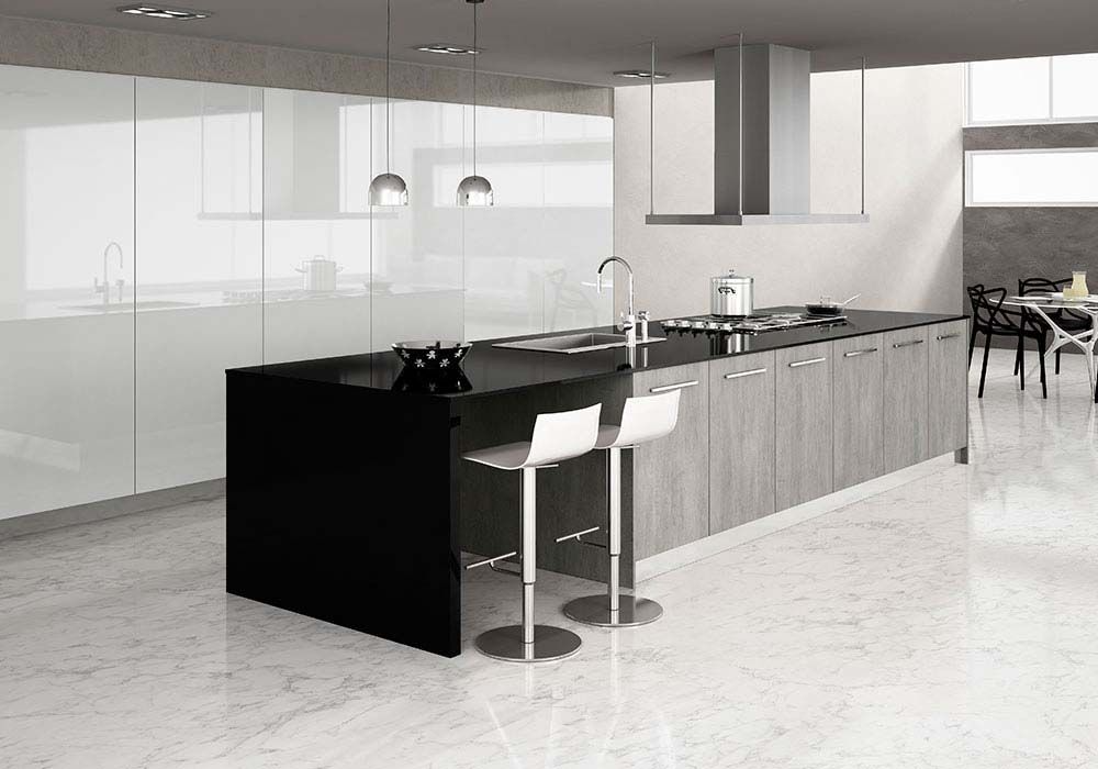 Una cocina con una isla negra y taburetes blancos.